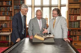 Shakespeare scholar Jonathan Bate (from left), Britain's King Charles III and Gregory Doran, artistic director emeritus of England's Royal Shakespeare Company, examine a First Folio that belonged to King Charles I nearly 400 years ago. The three discuss the historic tome in "Making Shakespeare: The First Shakespeare," part of PBS's "Great Performances" series. (Courtesy Royal Collection Trust / © His Majesty King Charles III)
