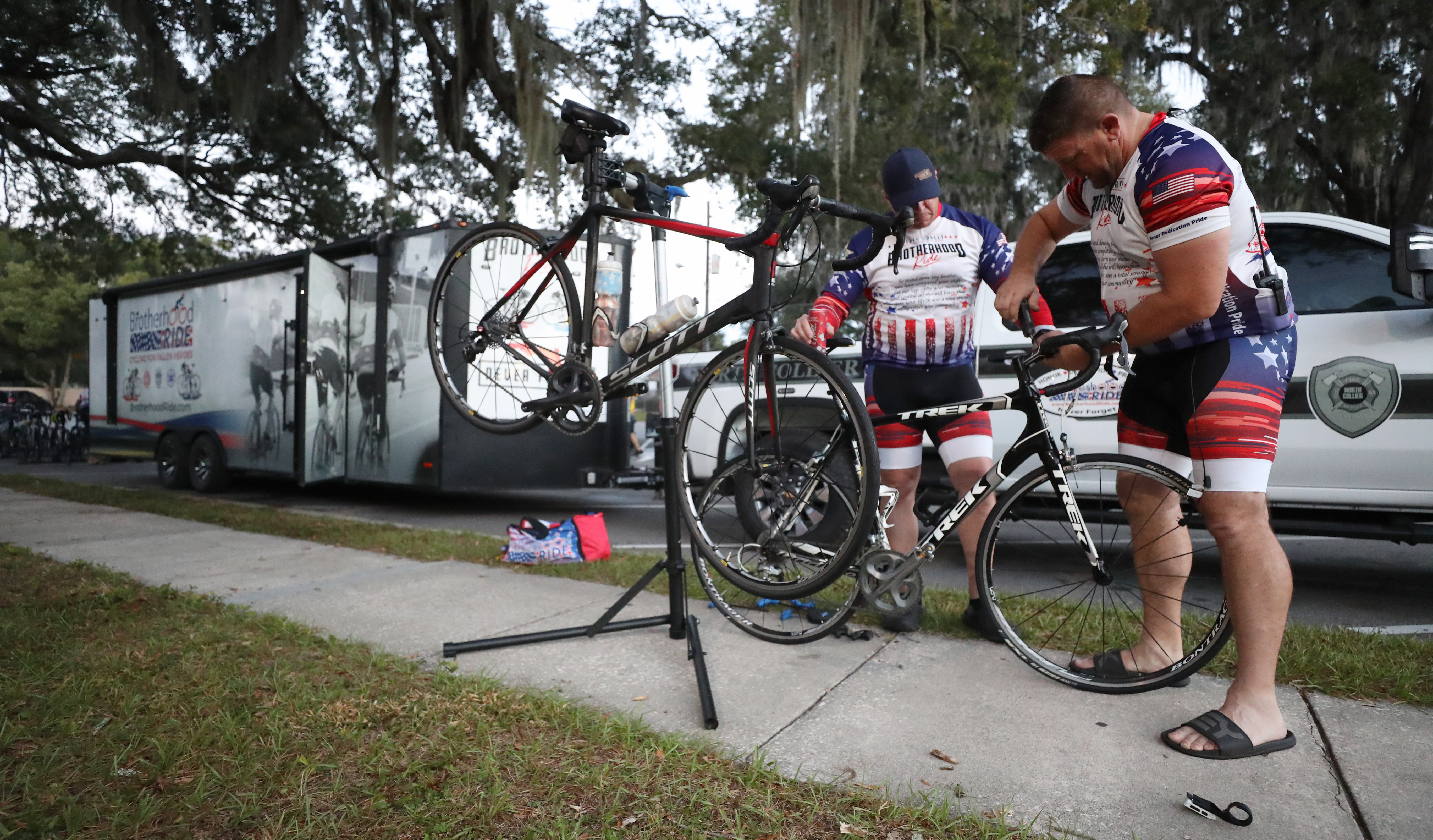 Left to Right, Michael Neal helps Shane Stauffer switch bicycles before the cyclist participating in the Brotherhood Ride depart Elks Lodge 1079, on their way to Cocoa Beach, on Tuesday, October 31, 2023. The ride is dedicated to the 28 Florida Fallen First Responders who died in the line of duty in 2022 while protecting their communities. They started in Naples and will end their 9-day ride through Florida in Miami.(Ricardo Ramirez Buxeda/ Orlando Sentinel)