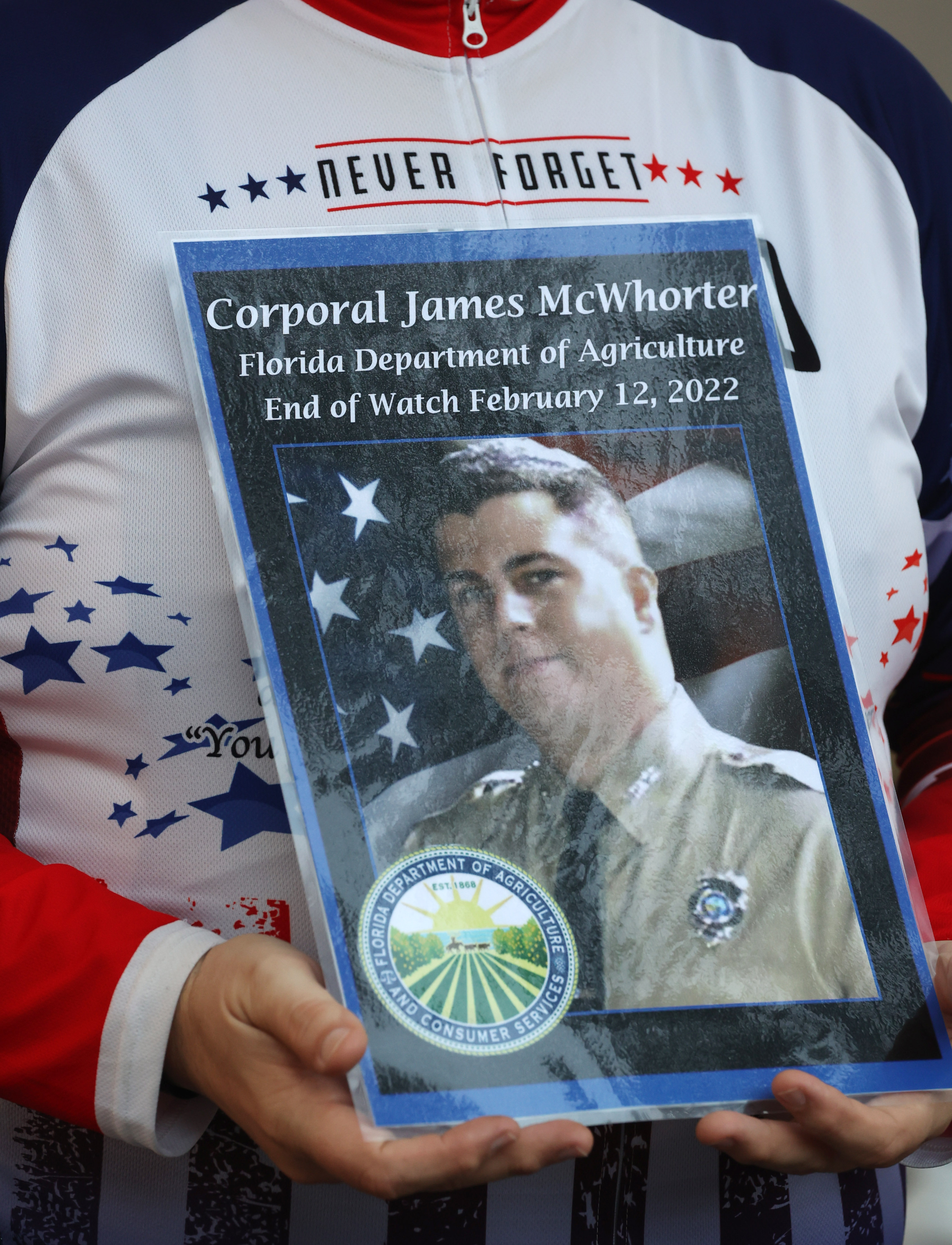 Remembrance poster for FL Department of Agriculture Corporal James McWhorter, before the Brotherhood Ride departs the Elks Lodge 1079, on their way to Cocoa Beach, on Tuesday, October 31, 2023. The ride is dedicated to the 28 Florida Fallen First Responders who died in the line of duty in 2022 while protecting their communities. They started in Naples and will end their 9-day ride through Florida in Miami.(Ricardo Ramirez Buxeda/ Orlando Sentinel)