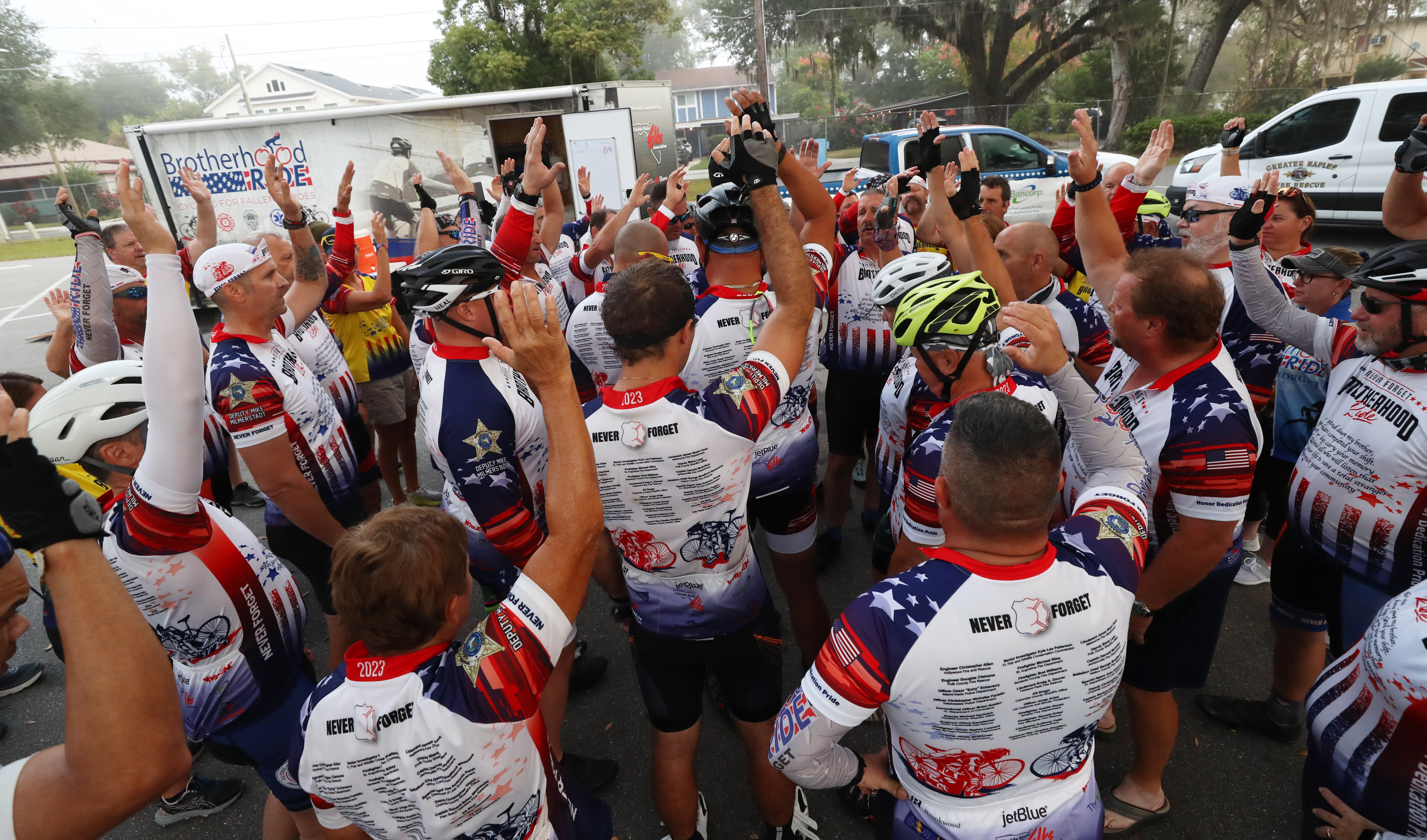 Cyclist participating in the Brotherhood Ride huddle before departing the Elks Lodge 1079, on their way to Cocoa Beach, on Tuesday, October 31, 2023. The ride is dedicated to the 28 Florida Fallen First Responders who died in the line of duty in 2022 while protecting their communities. They started in Naples and will end their 9-day ride through Florida in Miami.(Ricardo Ramirez Buxeda/ Orlando Sentinel)