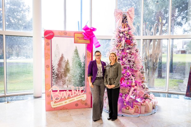 Tree designer Lindsay Matteoni of MSTR Studio, left, and Festival of Trees chair Donna Neck, a Council of 101 member, stand near Matteoni's Barbie-themed tree as the festival returns to Orlando Museum of Art for its 37th year with 50 designer trees on Nov. 9, 2023. The event, a fundraiser for the museum, goes on Nov. 11-19. (Patrick Connolly/Orlando Sentinel)