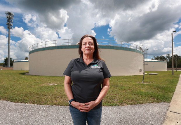 Seminole County Environmental Services director Kim Ornberg in front of water storage tanks at the Seminole Lake Markham Regional Water Treatment Plant in Sanford, Friday, July 7, 2023. (Joe Burbank/Orlando Sentinel)