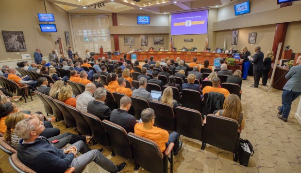With Visit Orlando supporters watching in orange T-shirts, Orange County commissioners debate the the tourist-tax-funded budget of the marketing agency. Visit Orlando is expected to get about $108 million next year under a 2019 agreement awarding it 30% of rising tourist-tax revenues.